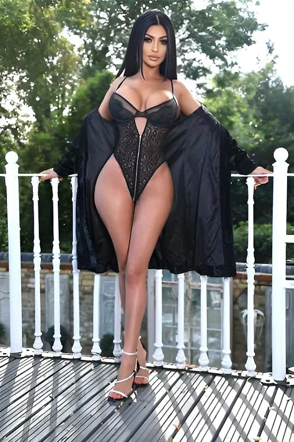 Melia is dressed in all black with sexy black heels and is on her balcony 