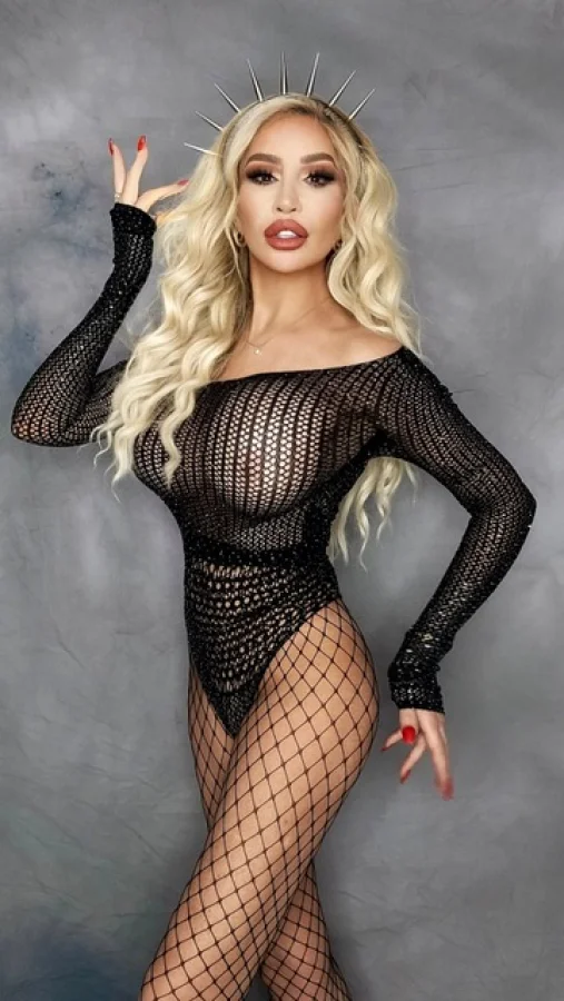 Elle is looking very sexy in a black mesh basque 