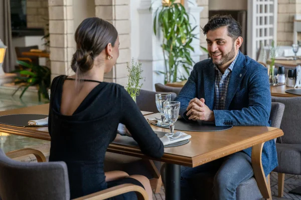 a man and a woman sitting at a table on a date