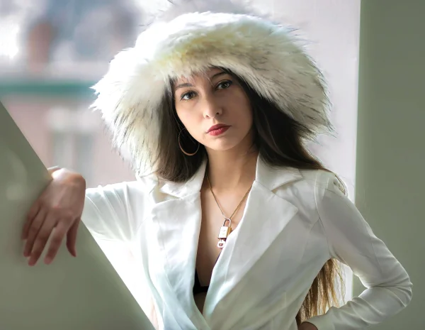an attractive Russian woman in a fur hat and white coat