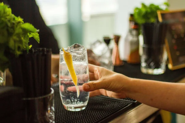 a person holding a drink in a bar