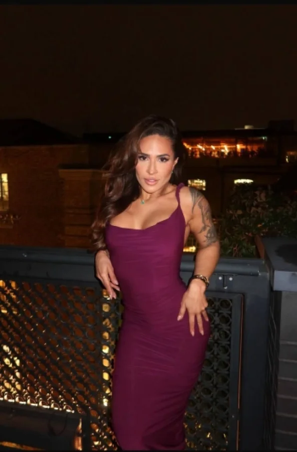 A picture of a curvy lady wearing a sexy purple dress 