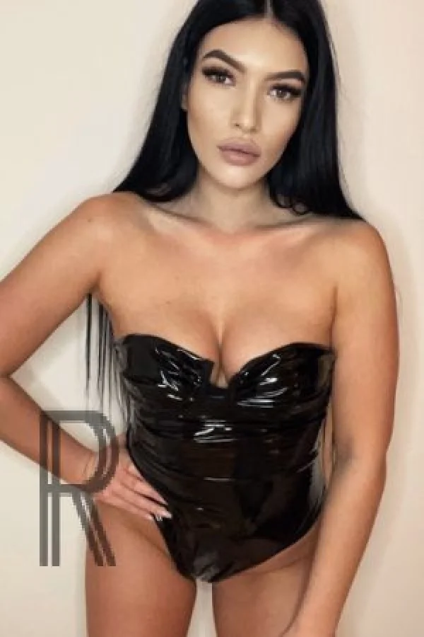 Sunny wearing a plastic latex corset 