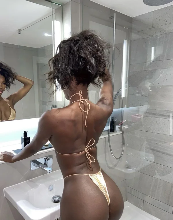 Beautiful black lady wearing a gold thong 