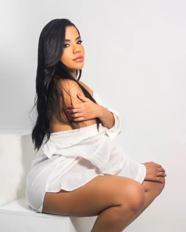 A very good looking brunette London escort with her shirt over her shoulders 