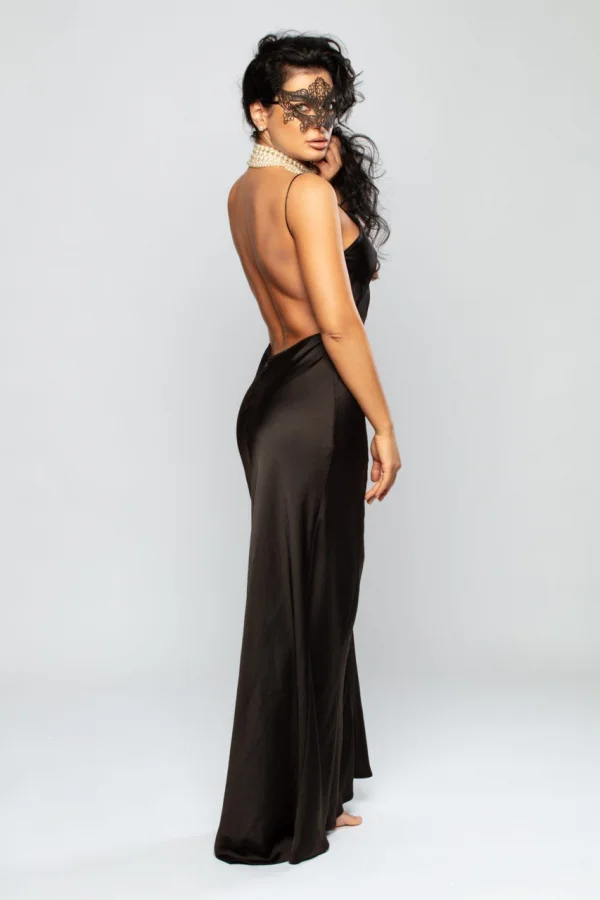 High class escort Belle is wearing a long black dress which is low cut at the back 