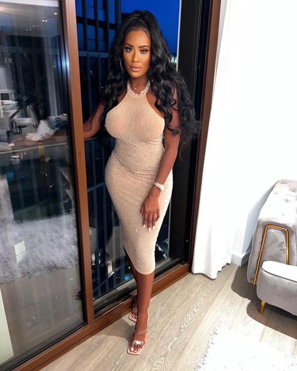 Busty ebony escort with big sexy lips pictured wearing a very sexy dress and see through heels 