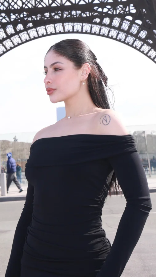 Brazilian escort standing by the Eiffel tower 