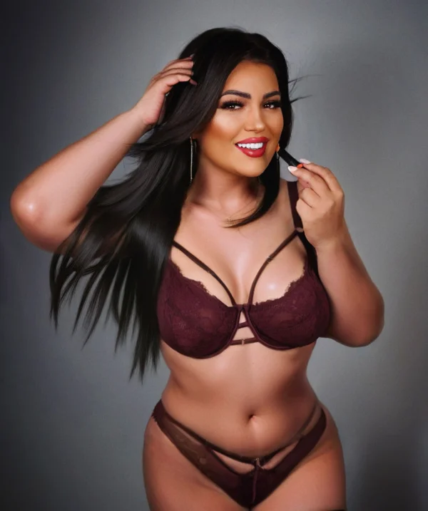 Flirty brunette Hope in lingerie, curvy London escort with a playful smile