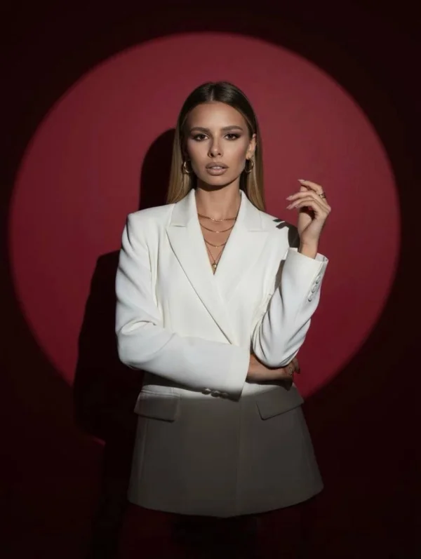A lady stood against a red back ground 