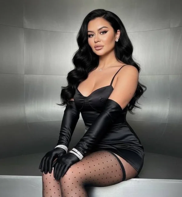 Reese looks sexy wearing a black dress and stockings 