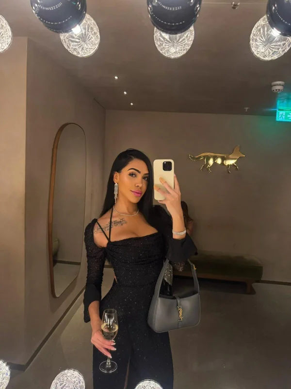 Beautiful brunette Brazilian escort wearing a tight sexy black dress 