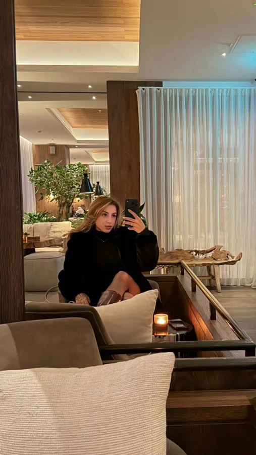 Lady sat in a hotel reception taking a selfie 