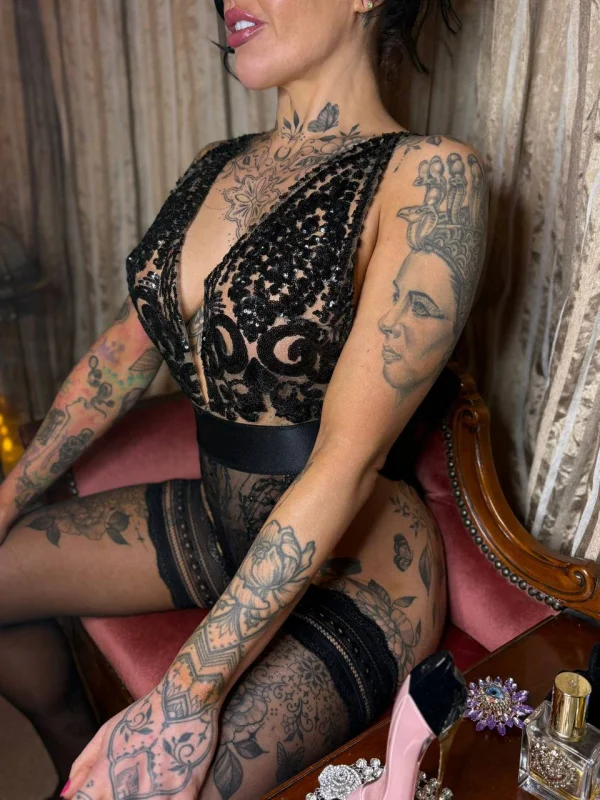 Close up photo of a heavily tattooed London escort