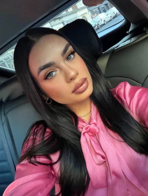 Blossom is taking a selfie while sat in her car 