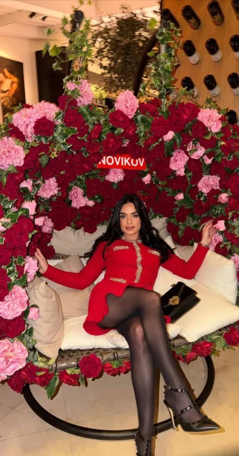 Blossom is sat on a large chair in Novikov 