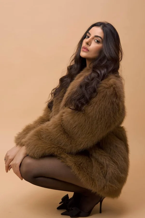 A beautiful brunette woman wearing a fur coat 