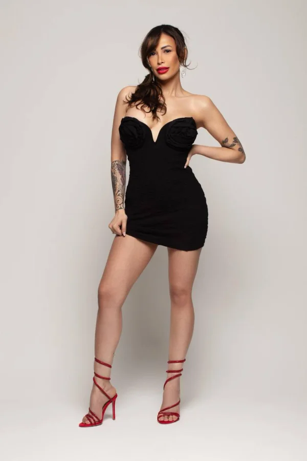 A very sexy lady dressed in black and wearing red fuck me heels 