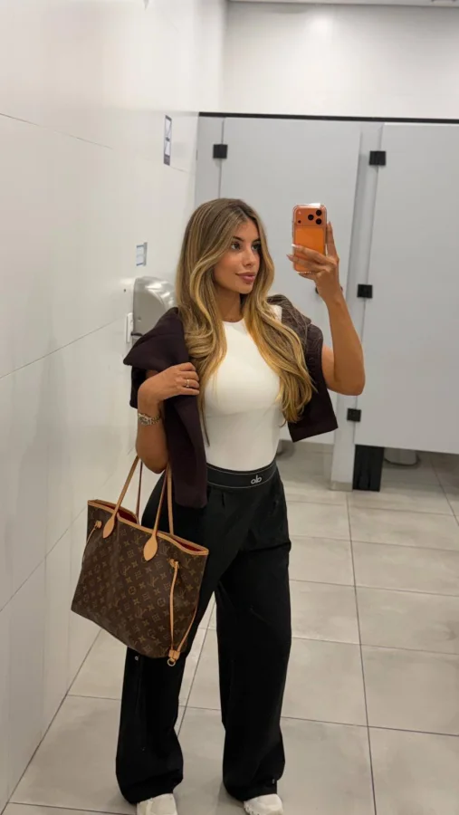 Woman taking a selfie of her outfit 