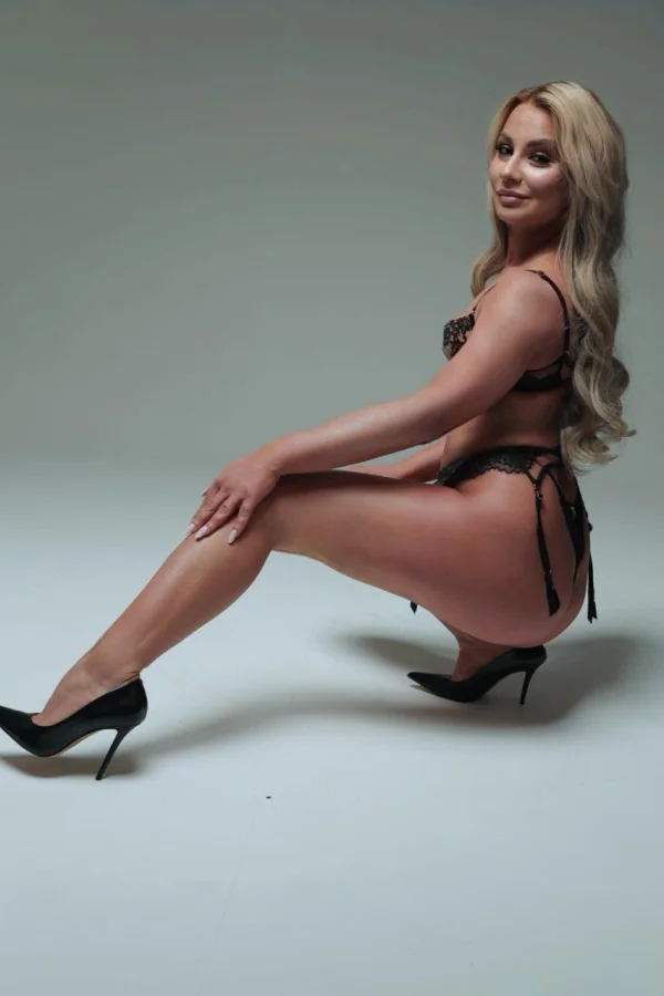 Verity has crouched down and put her leg out in front of her 
