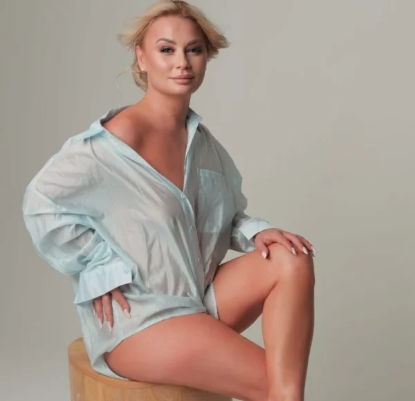 Verity is wearing a over sized shirt in this photo of her posing with a just got out of bed look 