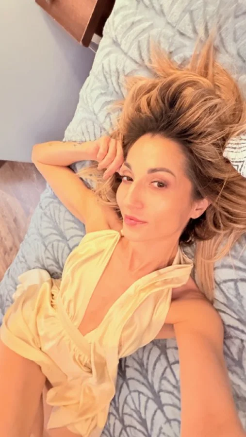 A beautiful picture of a beautiful lady laying on her bed 