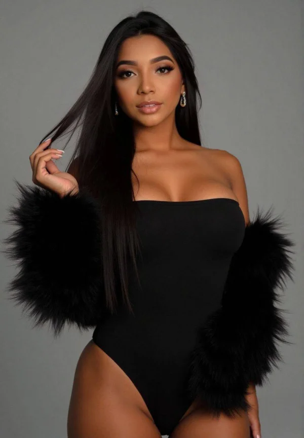 Jessamine wearing a glamorous black evening look with luxurious fur sleeves