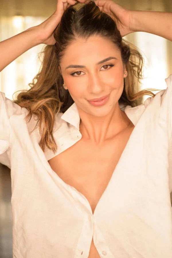 Brazilian brunette Kimberly smiling in an oversized white shirt