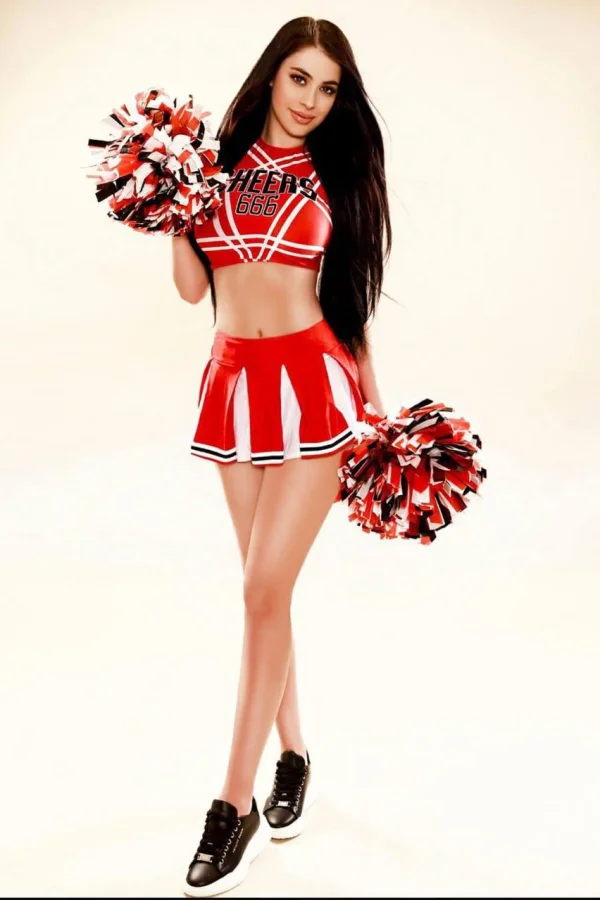 A very sexy brunette woman wearing a cheerleader outfit 