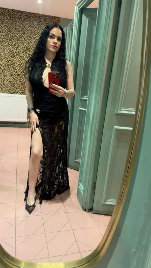 Mella wearing a black sheer robe during an indoor selfie