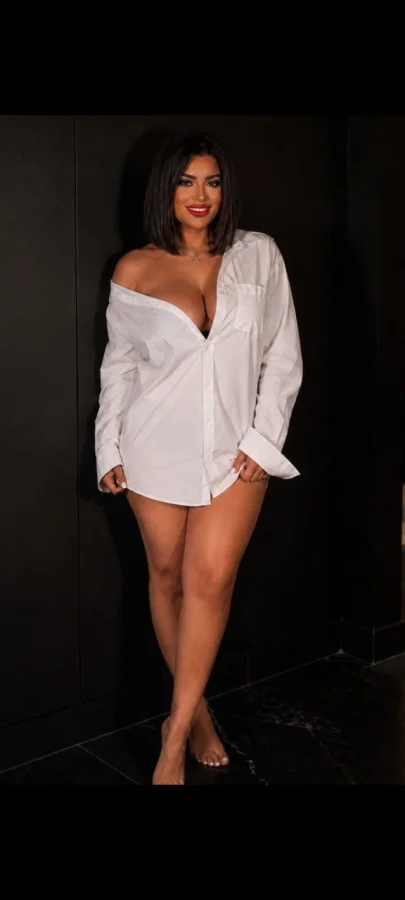Hope standing barefoot in an oversized white shirt