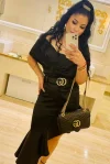 A very beautiful brunette escort took this mirror selfie of herself in a black dress 